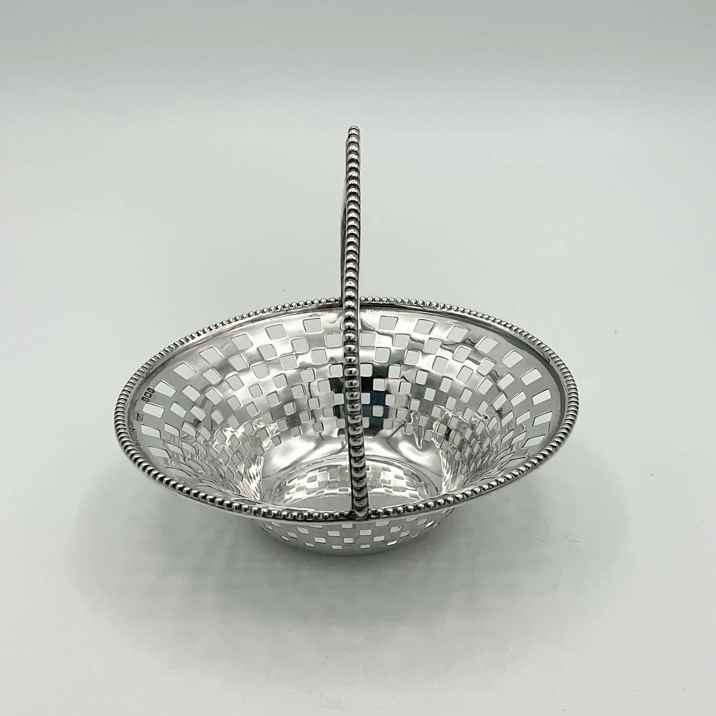 Side view of Antique Silver Basket with handle on white background