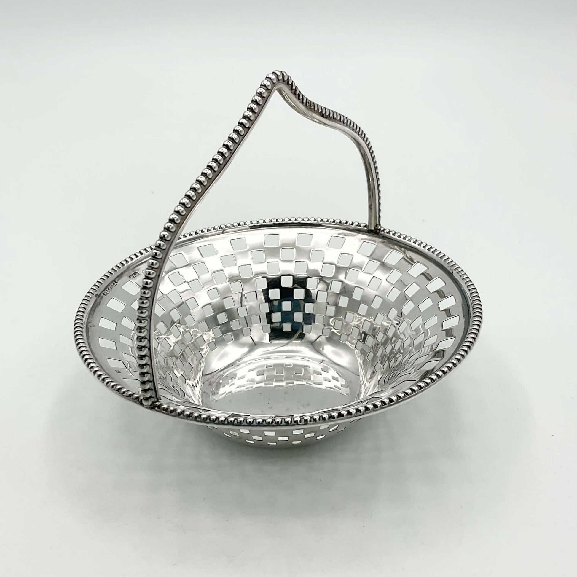 Antique Silver Basket with handle side view on white background 