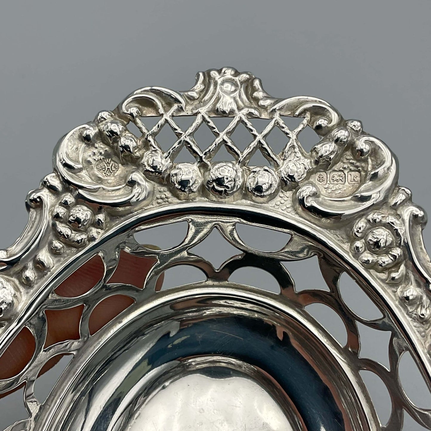 Hallmarks and makers mark hidden in the ornate design of the bowl