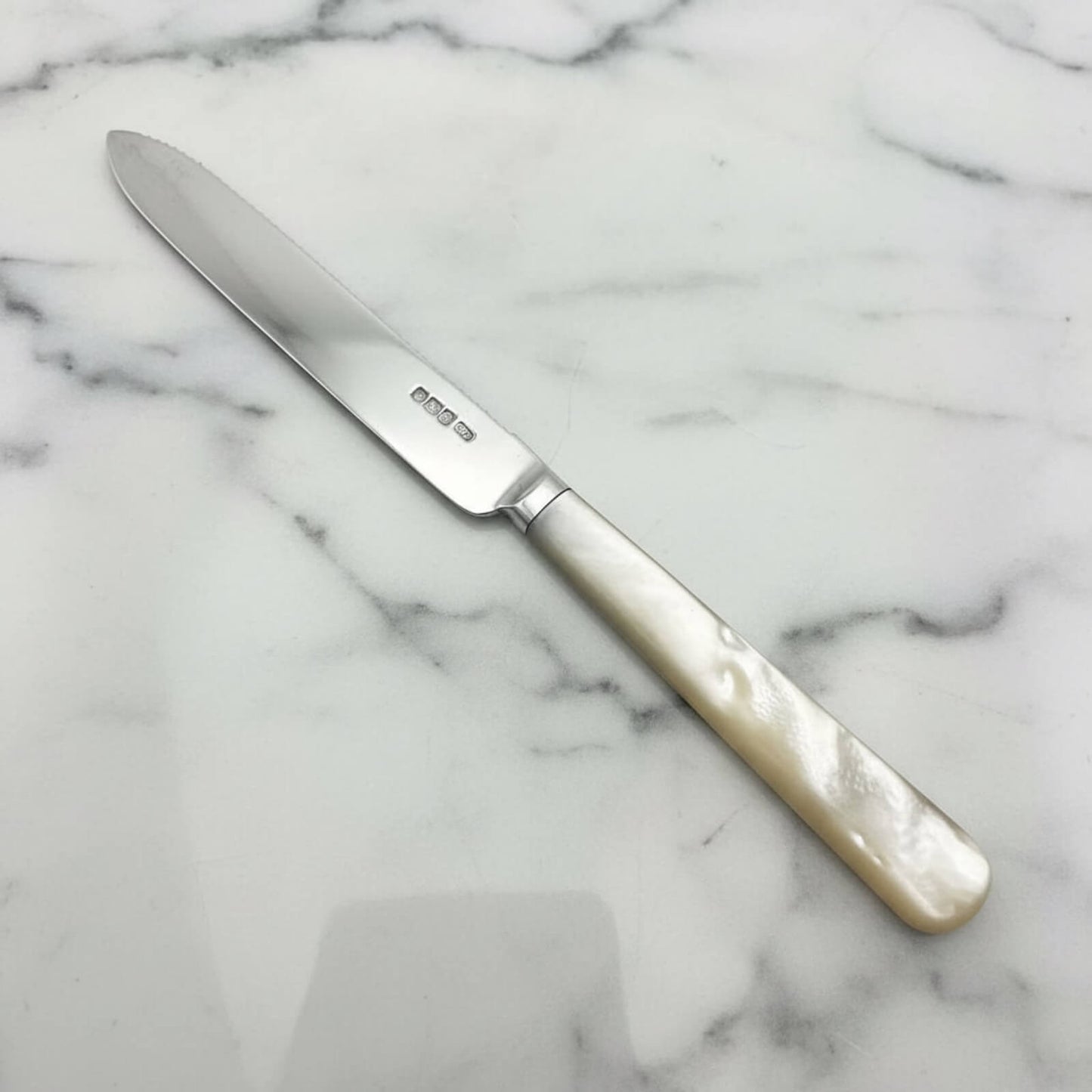 Knife with a decorative handle on a marble surface