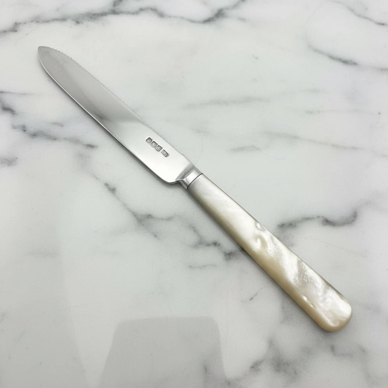 Knife with a decorative handle on a marble surface