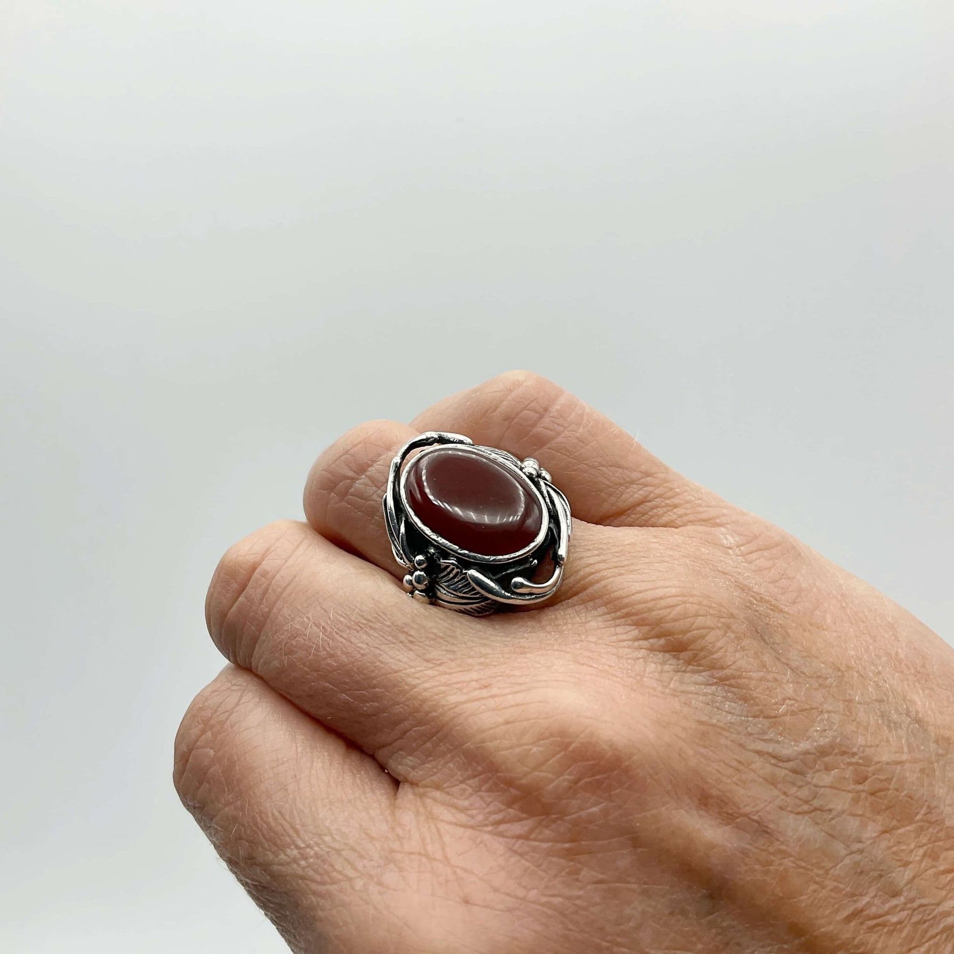 Beautiful orange Carnelian gemstone silver ring on a finger