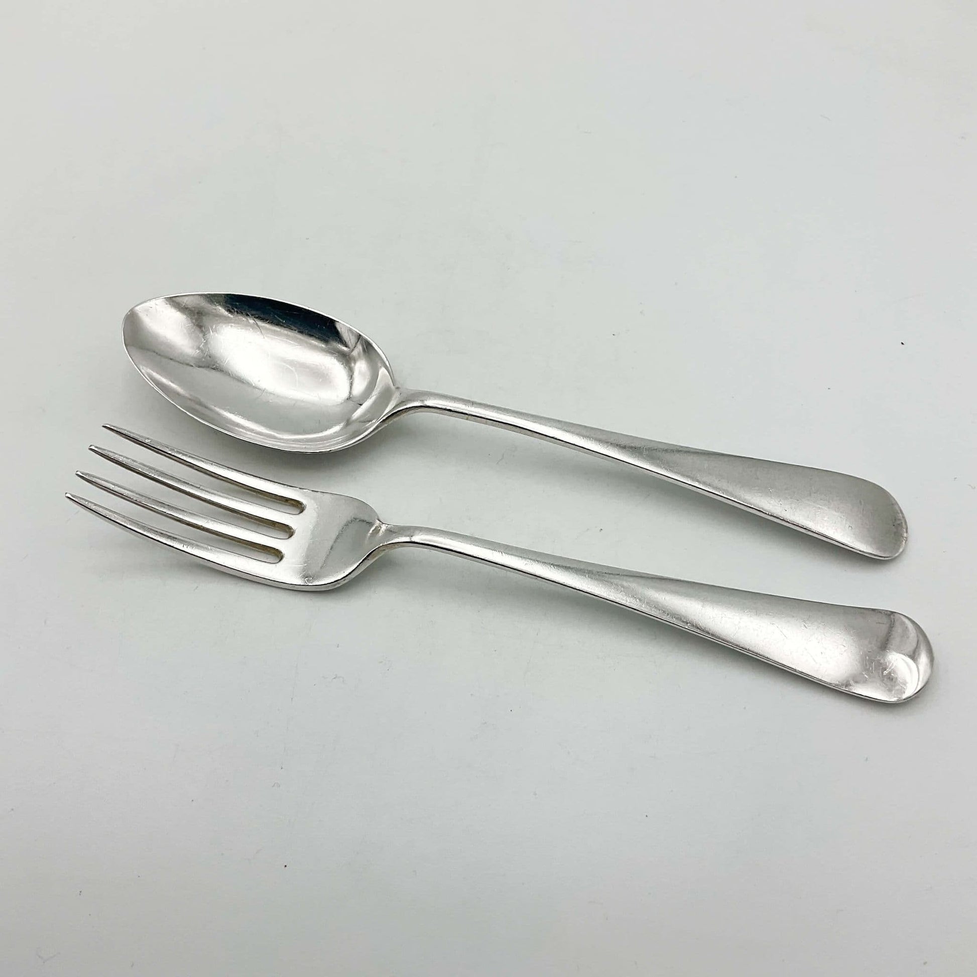 Child’s Solid silver fork and spoon set on white background 