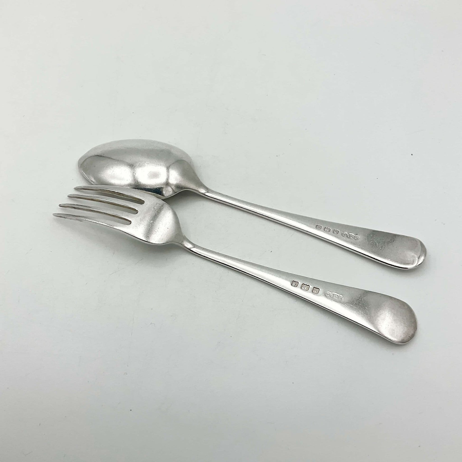  Silver spoon and for upside down on white surface