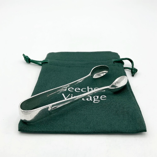 silver plated 1930s sugar tongs on a green gift bag