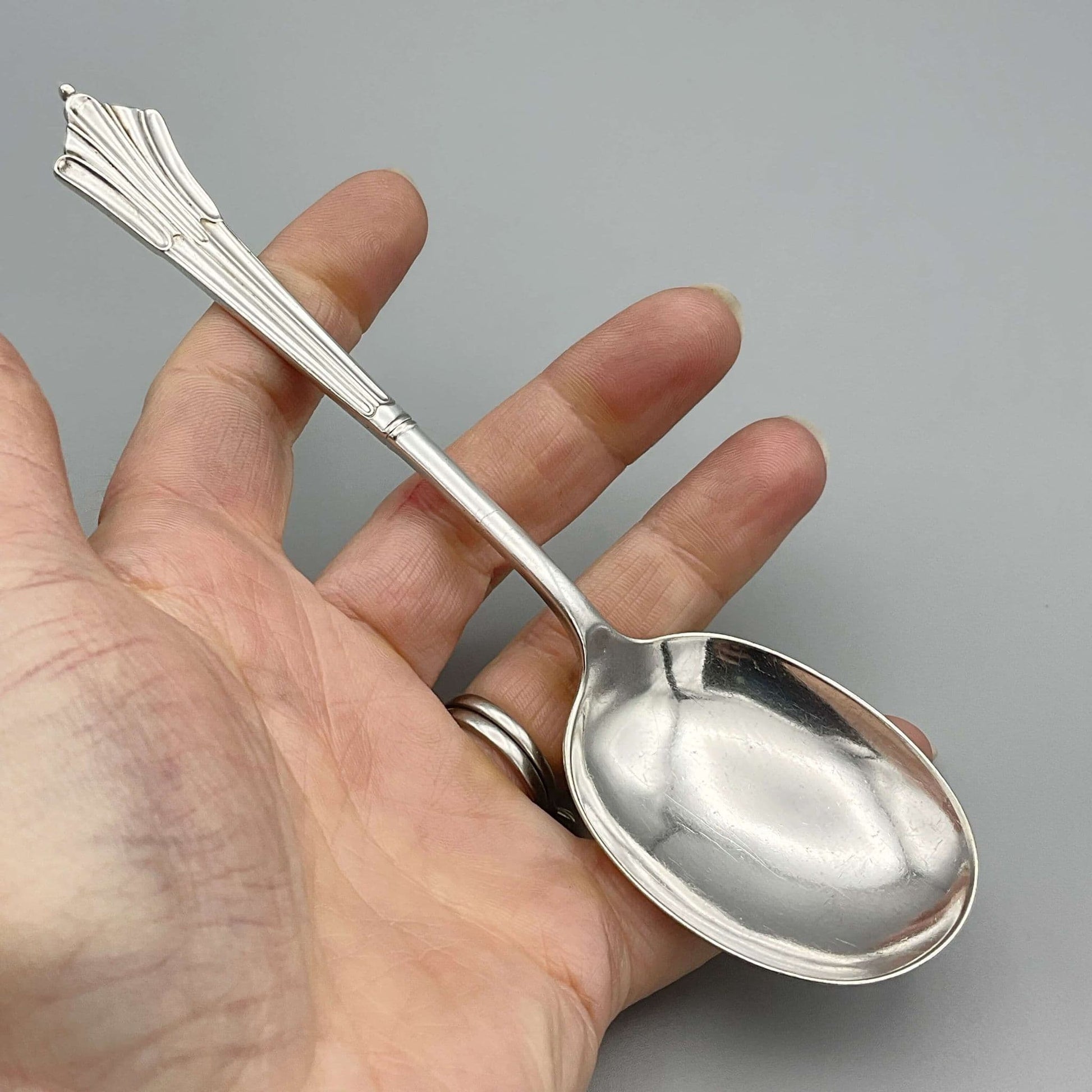 Beautiful 1940s Art Deco Dessert Spoon held in a hand