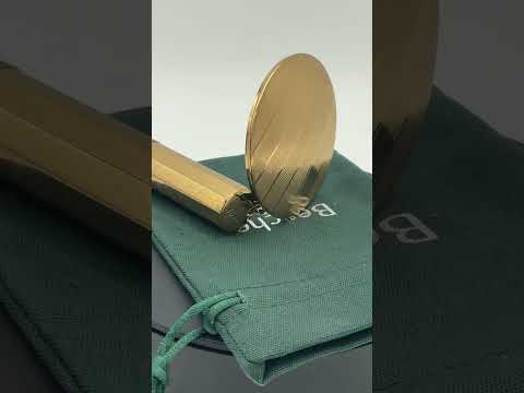 Video short of gold coloured lipstick case with mirror on a turntable.