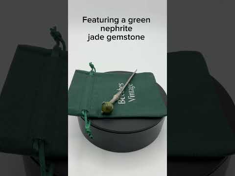 Video short of Sword shaped silver plated letter knife on a green gift bag