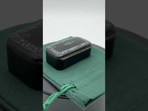 Video short of Antique black lacquer snuff box with multicoloured shell inlay on green gift bag