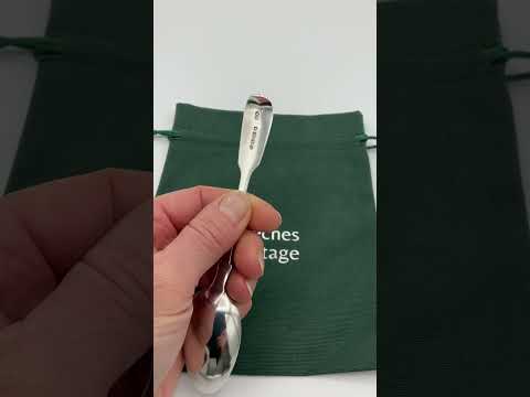 Video short of an antique silver teaspoon being held in a hand