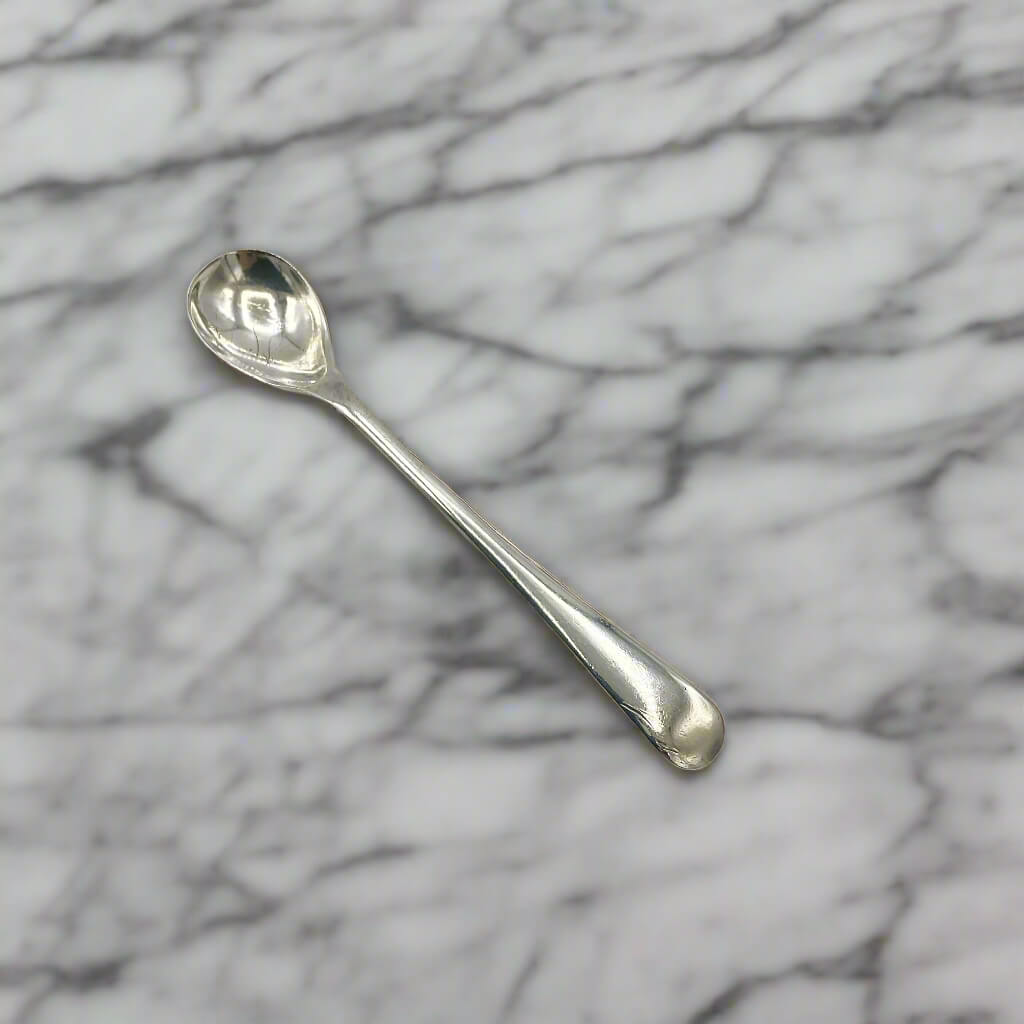 Silver spoon on a marble surface