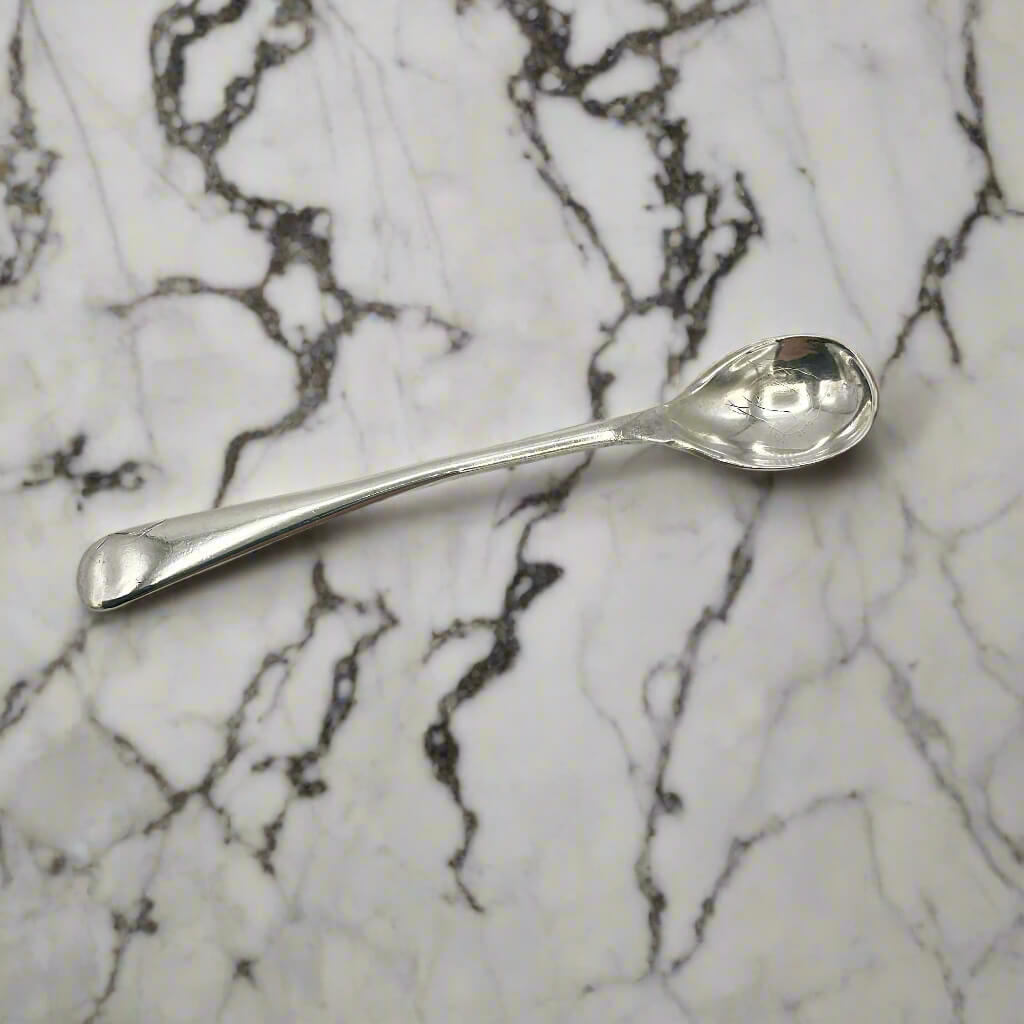 Silver spoon on a marble surface