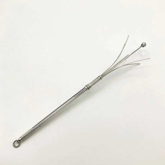 Silver whisk with decorative handle on a white background