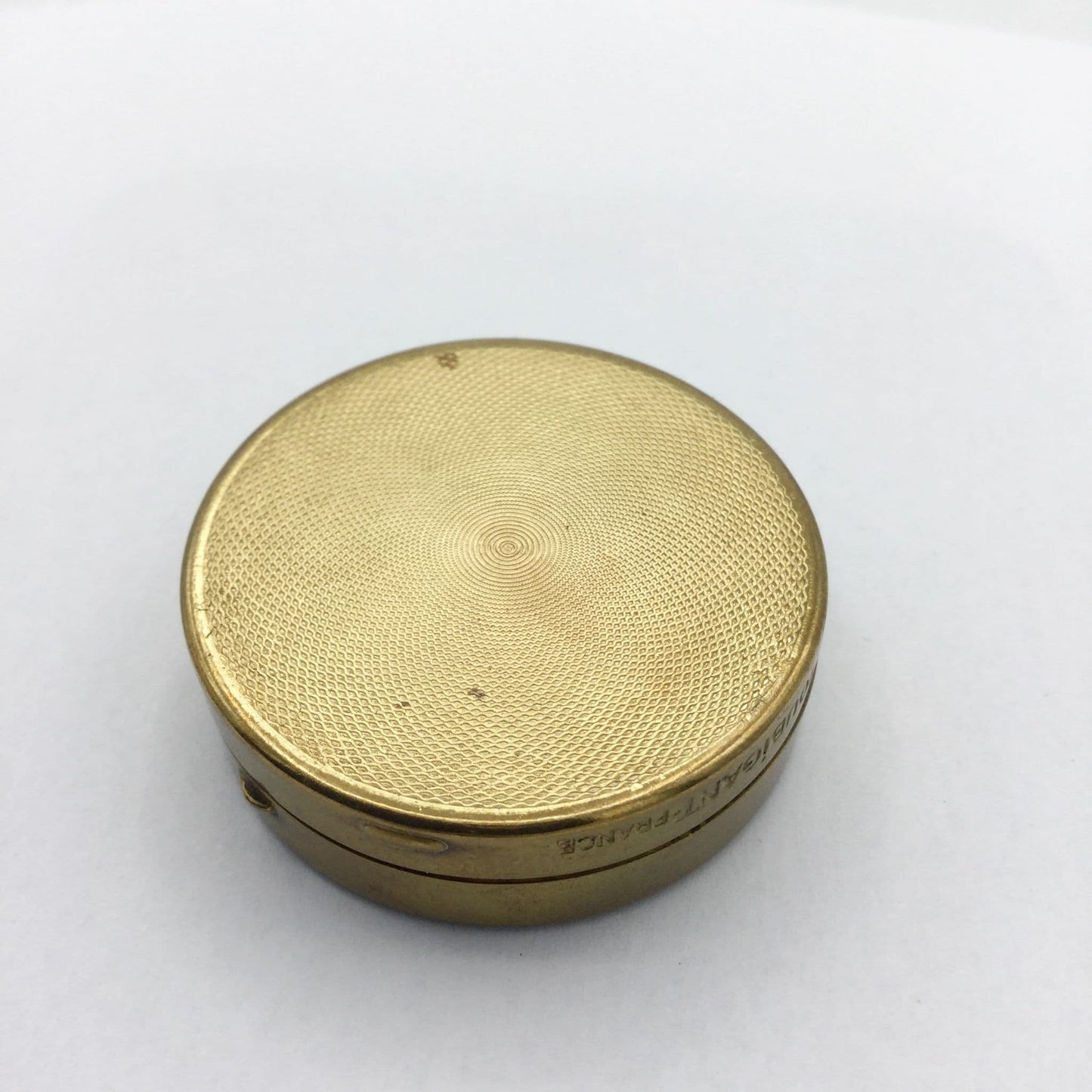 base of Houbigant brass compact showing a beautiful pattern