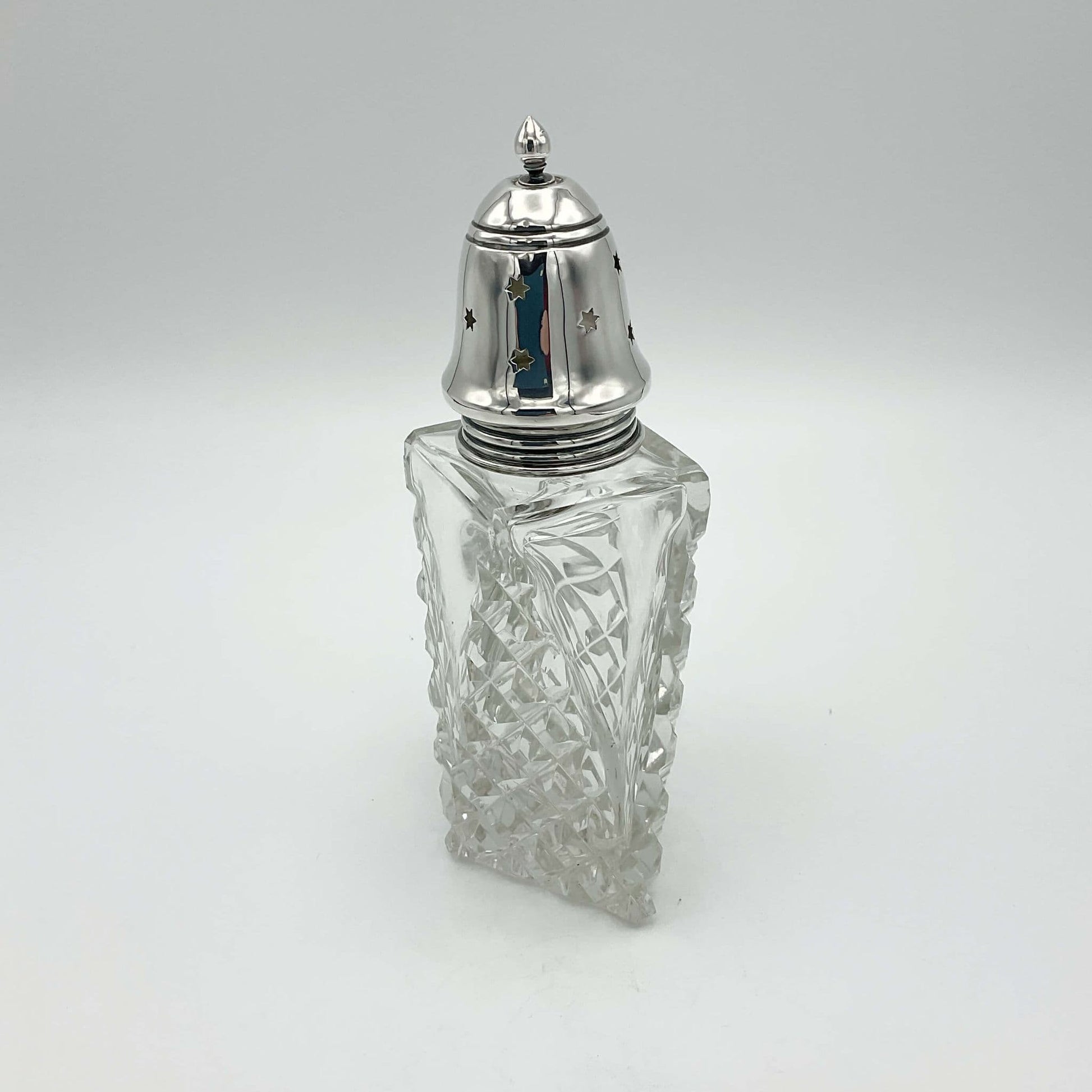 side view of diamond shaped Crystal glass and silver topped sugar shaker