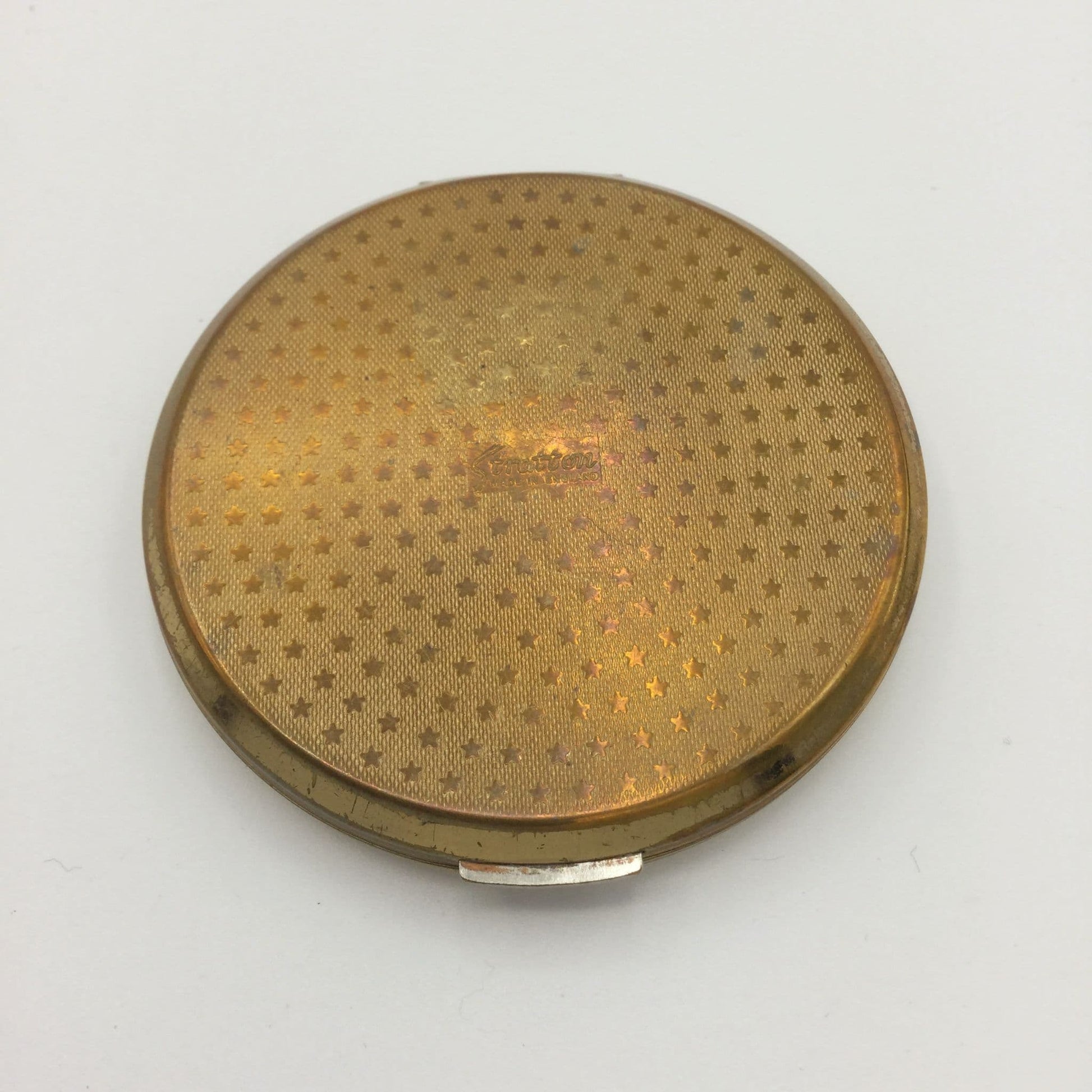 1960s gold mirror compact base showing a stars design with Stratton in the centre