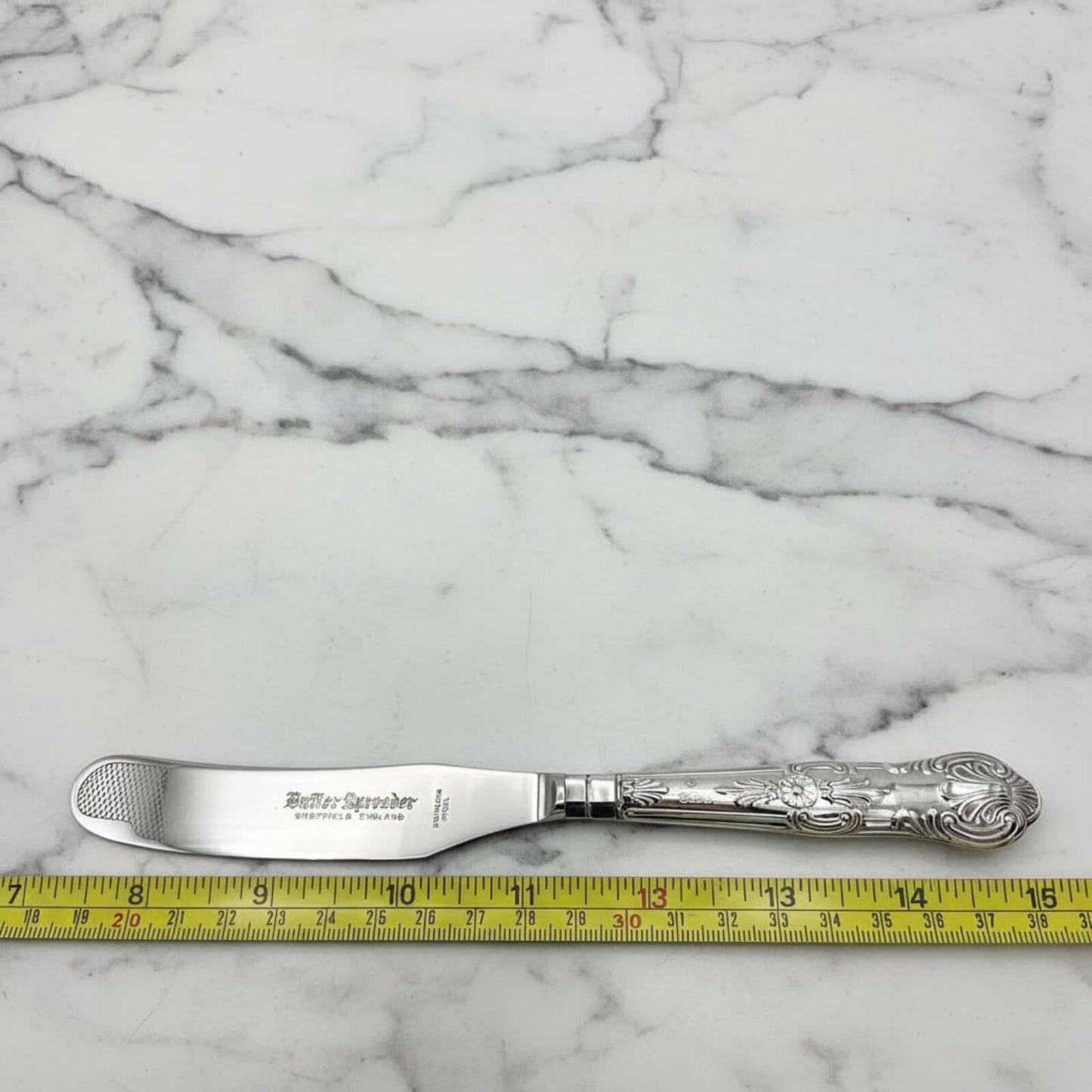 Vintage 1978 Sterling Silver Handled Butter Knife next to a tape measure for scale