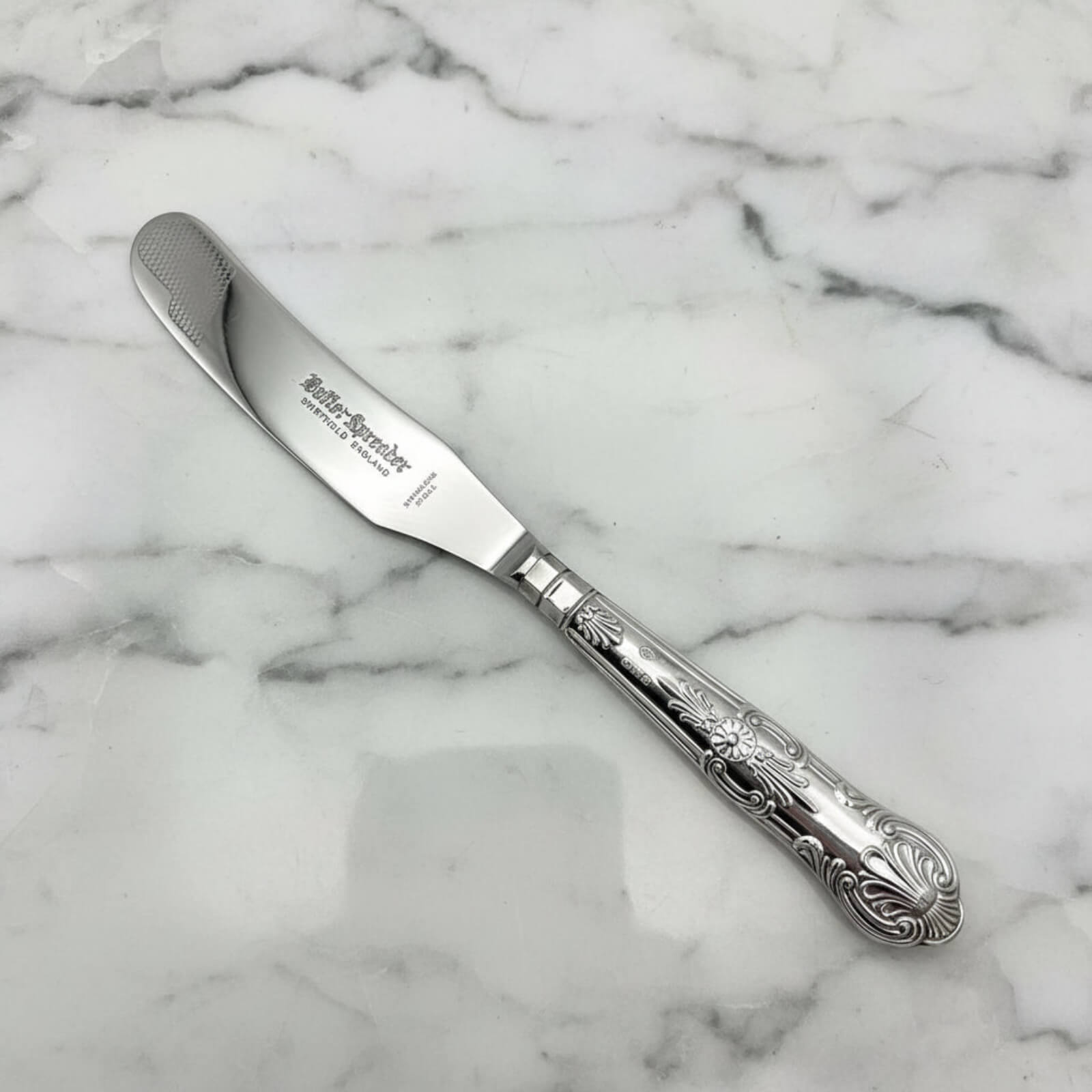 Vintage 1978 Sterling Silver Handled Butter Knife on a marble background