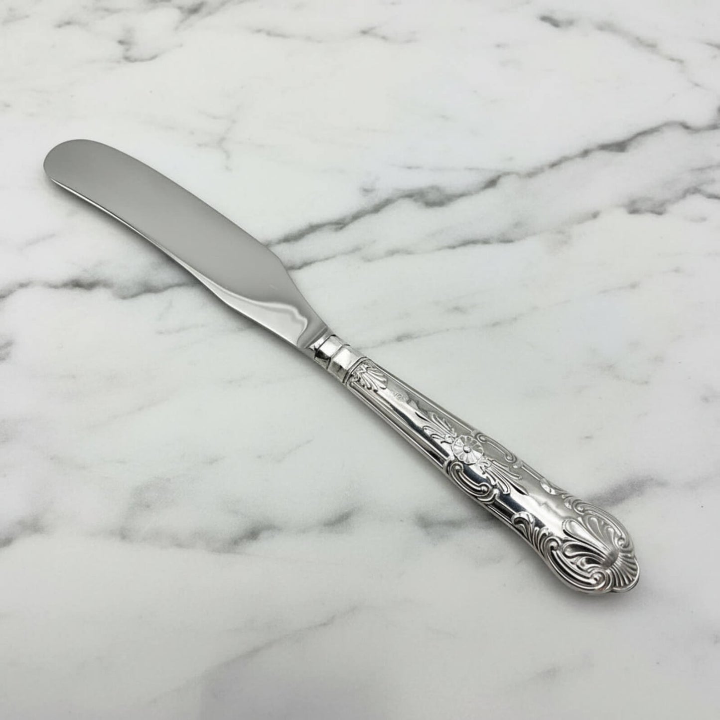 Vintage 1978 Sterling Silver Handled Butter Knife on a marble surface