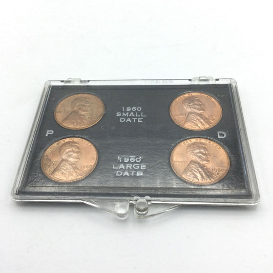 Four Lincoln Memorial Cents in a black holder and perspex case. It has P and D on the blakc holder and 1960 small date and 1960 large date on the black holder.