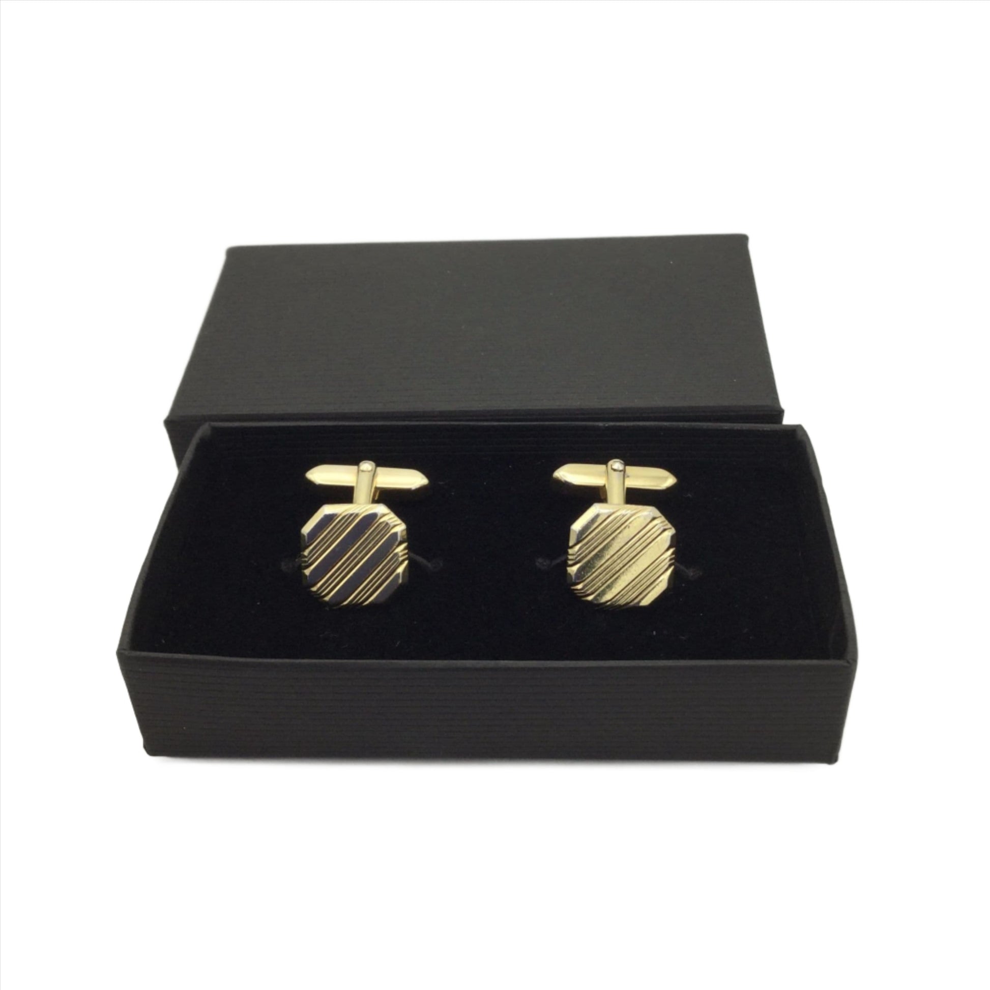 gold coloured square cufflinks with a striped pattern in an open black box