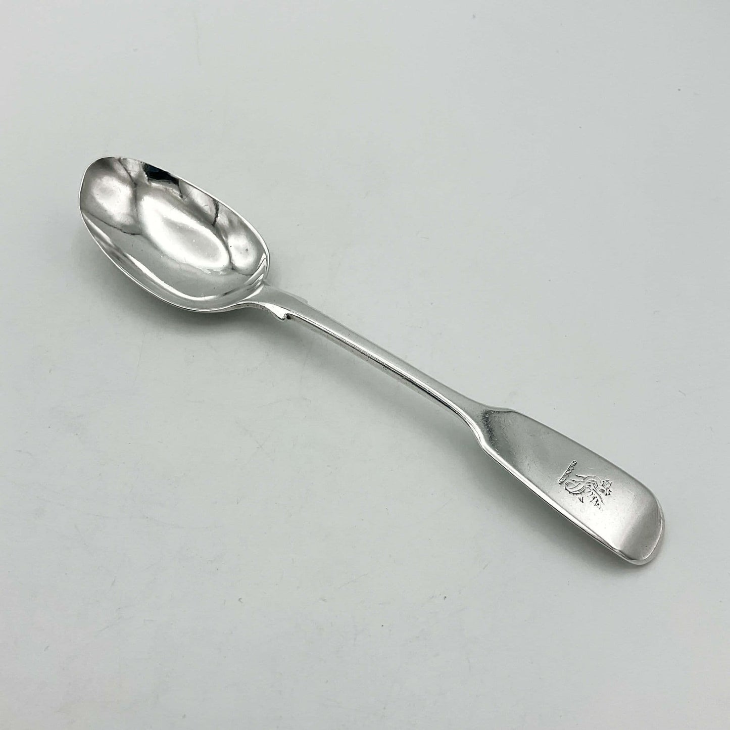 Antique silver teaspoon on a white background