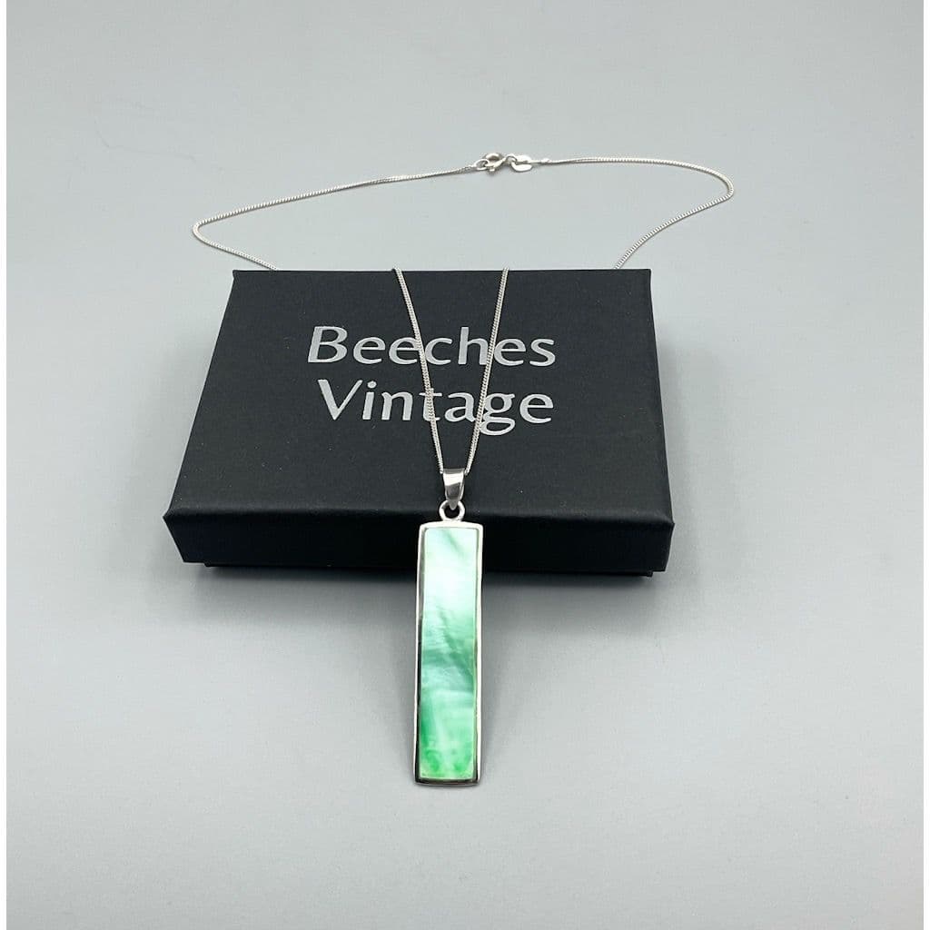 Green mother of pearl pendant necklace on a presentation box